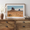 A framed or unframed fine art photography desert print of a horse in Monument Valley, Utah. This wall art features unique rock formations native to the Monument Valley area. This horse wall art comes in different sizes, including extra large.