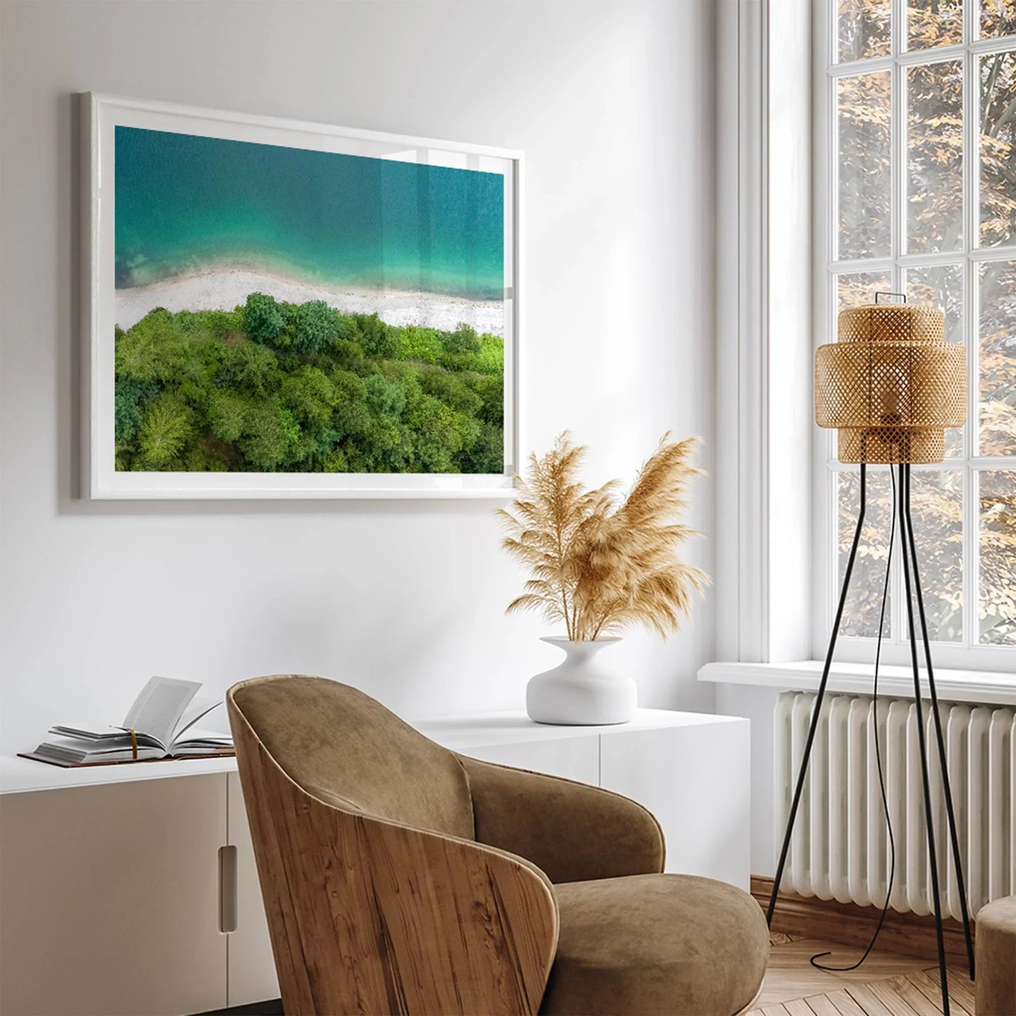 A fine art beach print from above with emerald colors and lush forest.