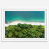A fine art beach print from above with emerald colors and lush forest.