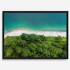 A fine art beach print from above with emerald colors and lush forest.