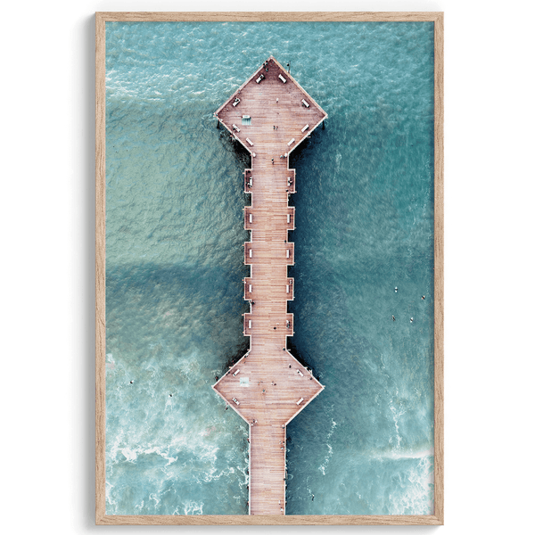 A fine art aerial beach pier photography pier. This ocean drone photography print was taken in Pismo Beach, California 300 feet above the ground. The result is minimalist geometrical wall art that brings out the beauty of the Pacific Ocean.