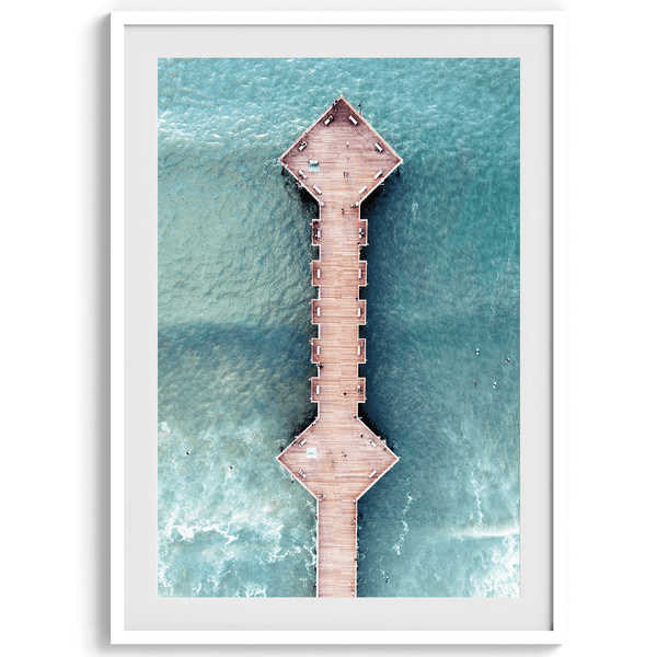 A fine art aerial beach pier photography pier. This ocean drone photography print was taken in Pismo Beach, California 300 feet above the ground. The result is minimalist geometrical wall art that brings out the beauty of the Pacific Ocean.