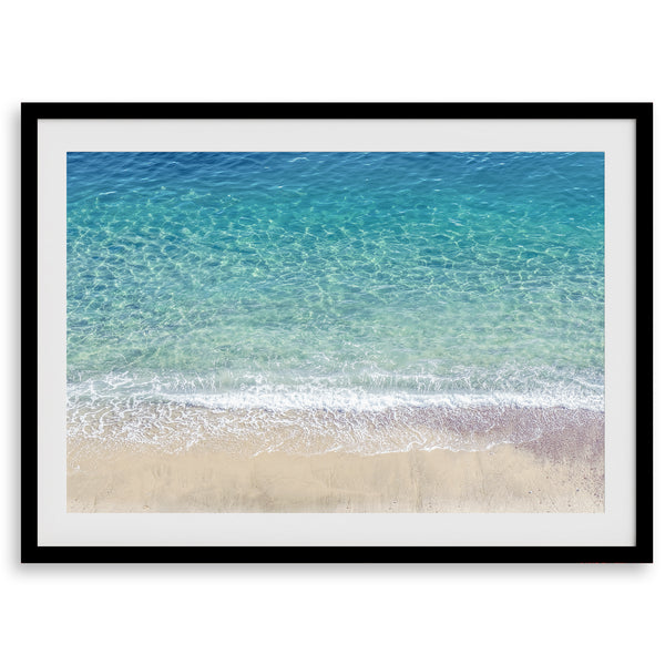 This fine art aerial beach print showcases the mesmerizing colors of the ocean in vivid detail. From the deep blue depths to the vibrant greenish turquoise blue, transitioning to the golden sandy beach and the crashing white surf.