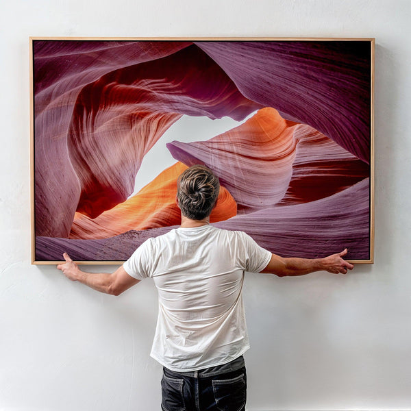 Vivid Antelope Canyon canvas featuring glowing sandstone curves in warm orange, red, and purple hues with sunlight streaming through.