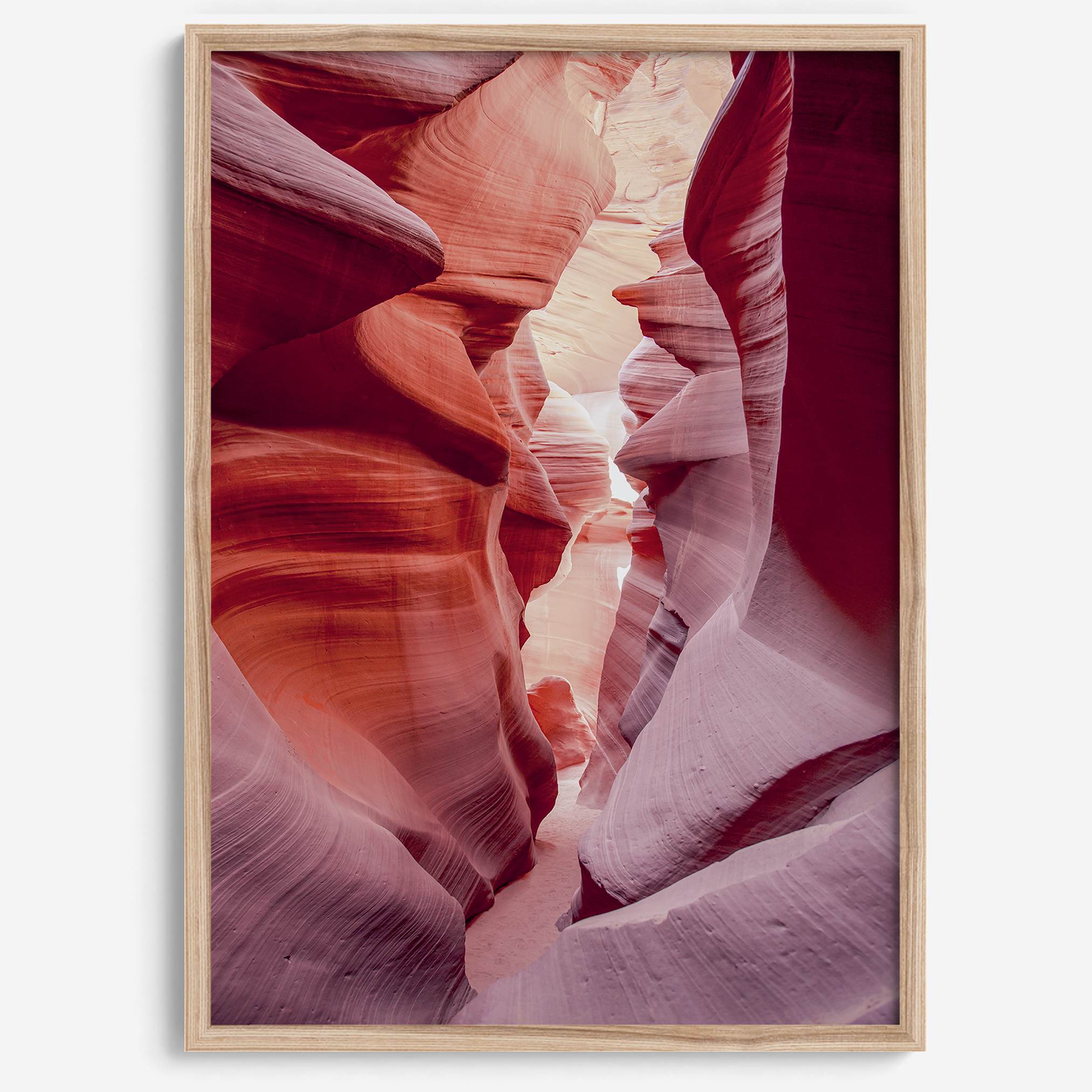 This beautiful Arizona desert wall art captures the mesmerizing beauty of Antelope Canyon. The picture showcases a passage through the rock in the canyon, with vibrant pink and purple textures that create a sense of depth and dimension.