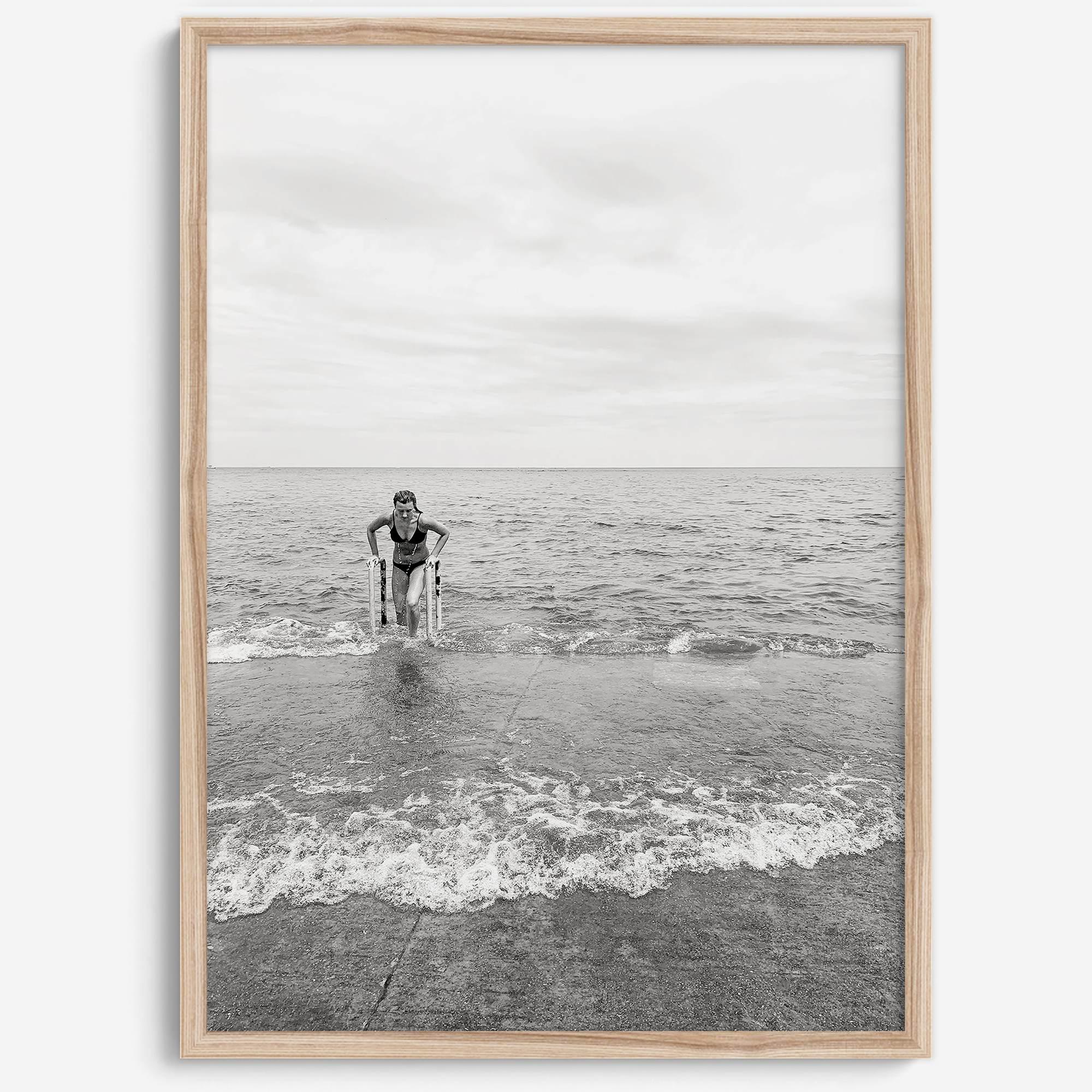 A black and white fine art lake beach print of a beach in Chicago on the coast of Lake Michigan showcasing a woman bathing in the lake. The classic modern look of the print is sure to impress when hung on your walls.