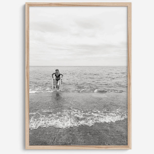 A black and white fine art lake beach print of a beach in Chicago on the coast of Lake Michigan showcasing a woman bathing in the lake. The classic modern look of the print is sure to impress when hung on your walls.
