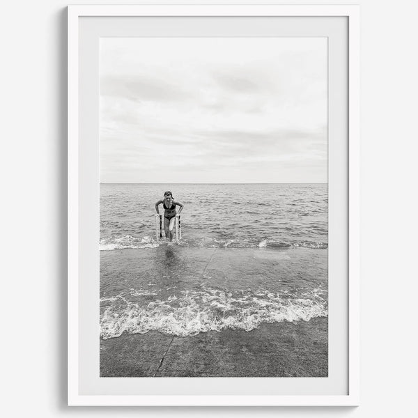 A black and white fine art lake beach print of a beach in Chicago on the coast of Lake Michigan showcasing a woman bathing in the lake. The classic modern look of the print is sure to impress when hung on your walls.