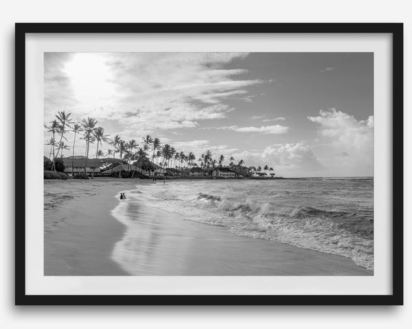 Black and white tropical wall art featuring a serene sunrise on a beach in Kauai, Hawaii with palm trees