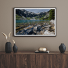 A framed fine art landscape print of a crystal-clear blue lake in Washington State. The tranquil water reveals colorful rocks beneath the surface, with snow-capped mountains towering in the distance.