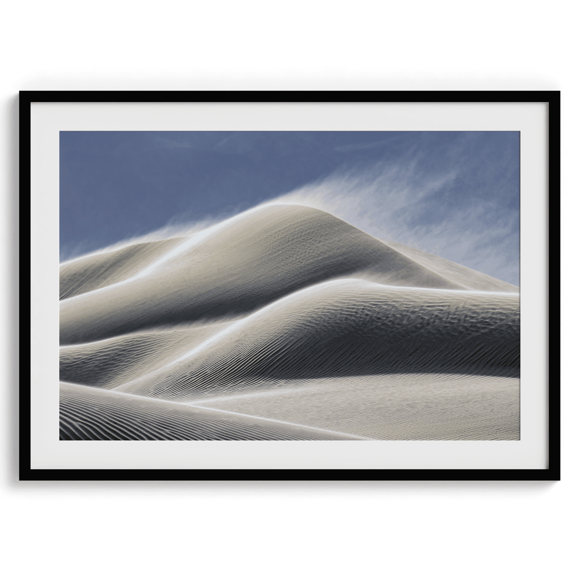 Fine art photo of Mesquite Flat Sand Dunes in Death Valley at golden hour. Windblown sand creates textured patterns across the immense dunes, bathed in warm light.