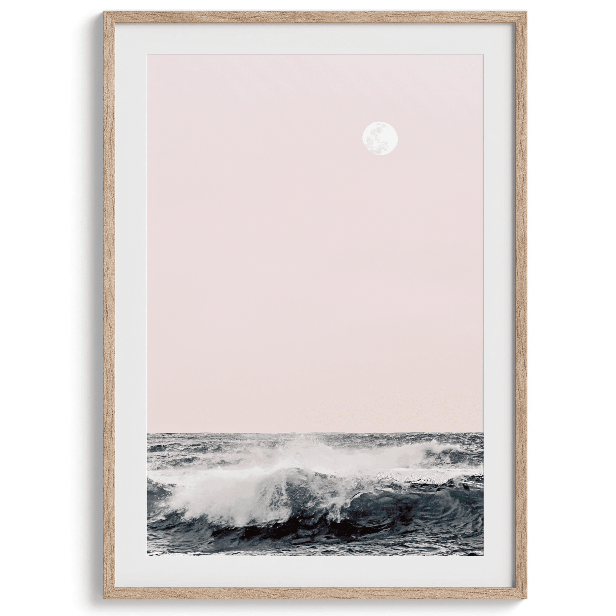 This extraordinary ocean wall art captures a mesmerizing moment when a powerful wave crashes while the sunset gentle blush pink hues fill the sky and a large full moon rises majestically in the backdrop.