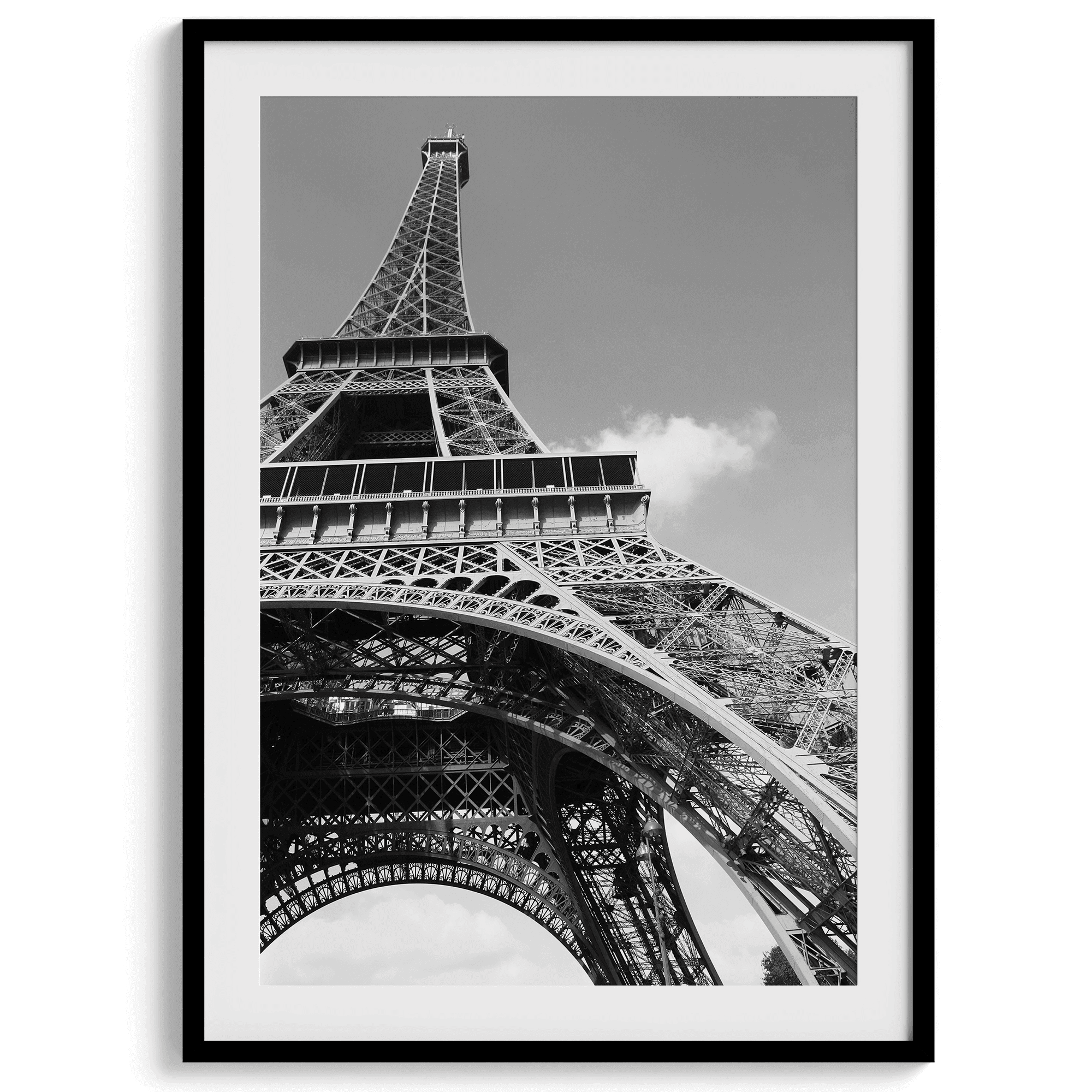 A fine art Eiffel Tower black and white print. This Paris theme wall art showcases a unique wide-angle view from the bottom of the tower, creating a modern, trendy fine art photography to hang on your walls.