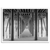 A large fine art abstract black and white beach pier print This stunning beach wall art shows the symmetric structure of the pier with the ocean water gently caressing the pier and beach.