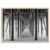 A large fine art abstract black and white beach pier print This stunning beach wall art shows the symmetric structure of the pier with the ocean water gently caressing the pier and beach.