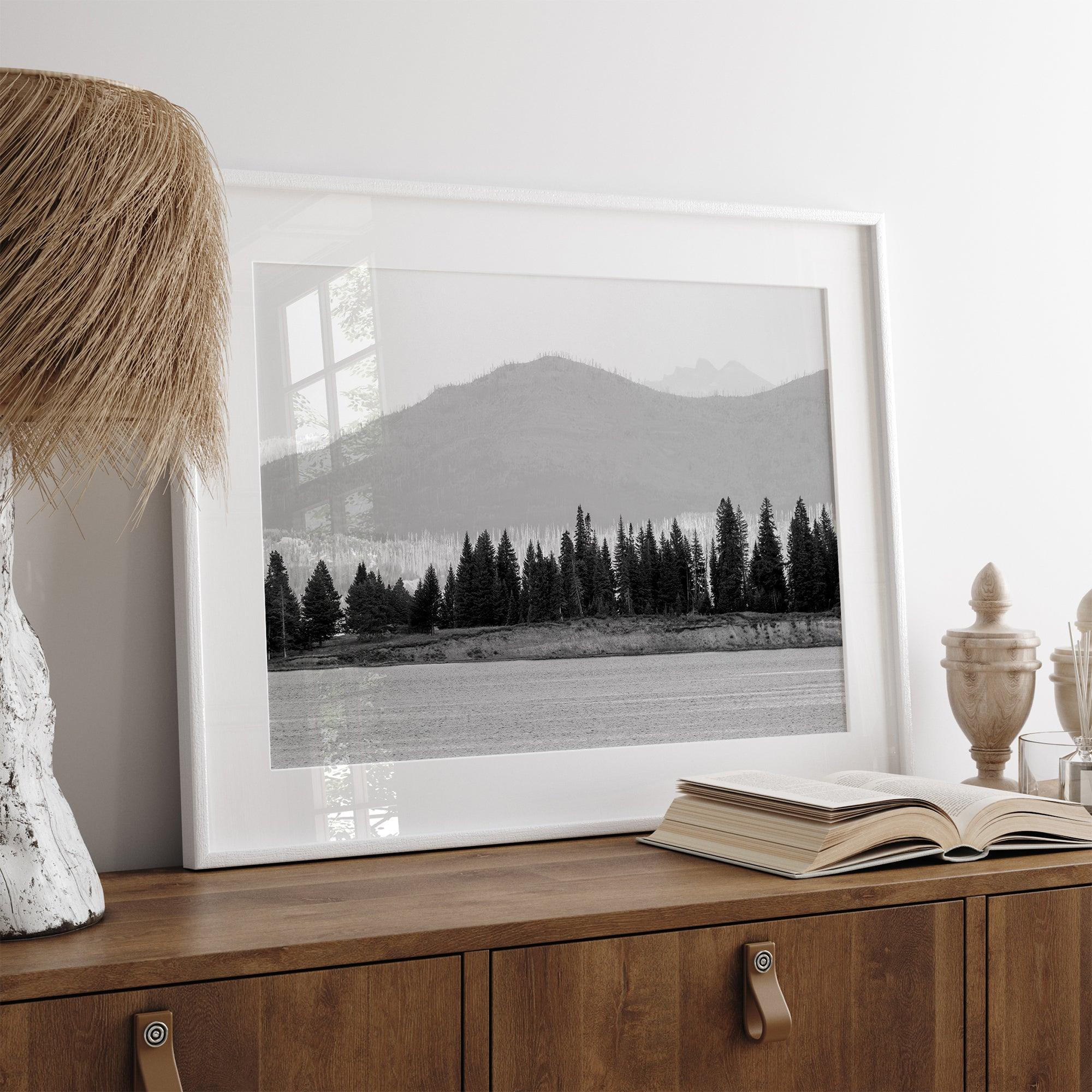 Abstract nature art of a forested island on Yellowstone Lake with black-and-white photography and misty mountains.