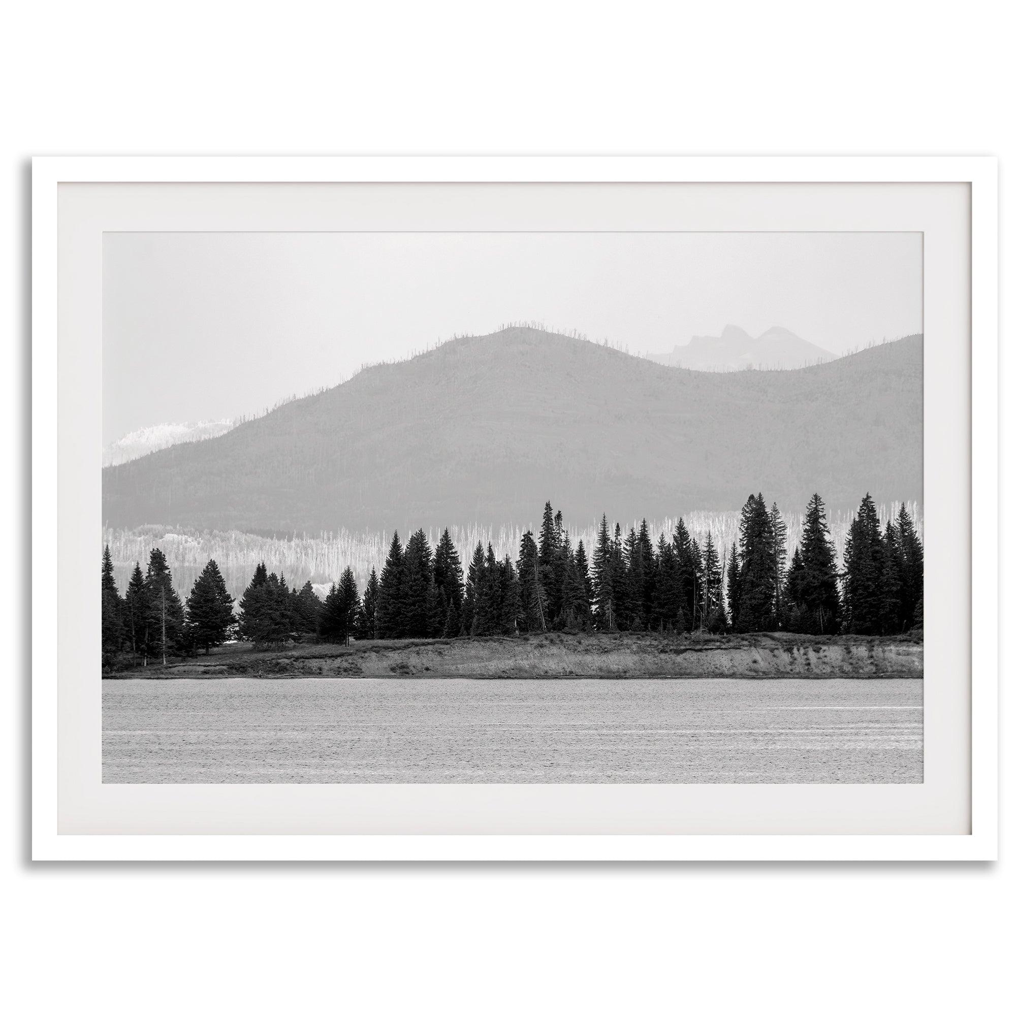 Abstract nature art of a forested island on Yellowstone Lake with black-and-white photography and misty mountains.