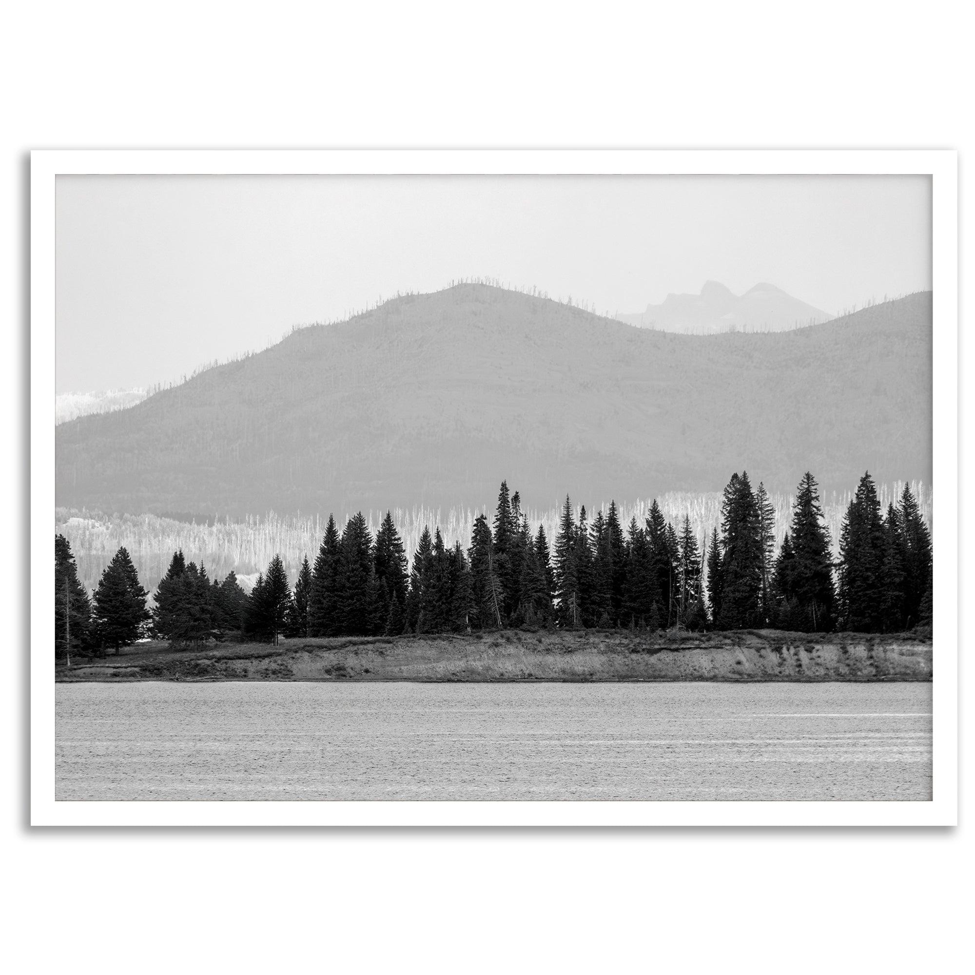 Abstract nature art of a forested island on Yellowstone Lake with black-and-white photography and misty mountains.