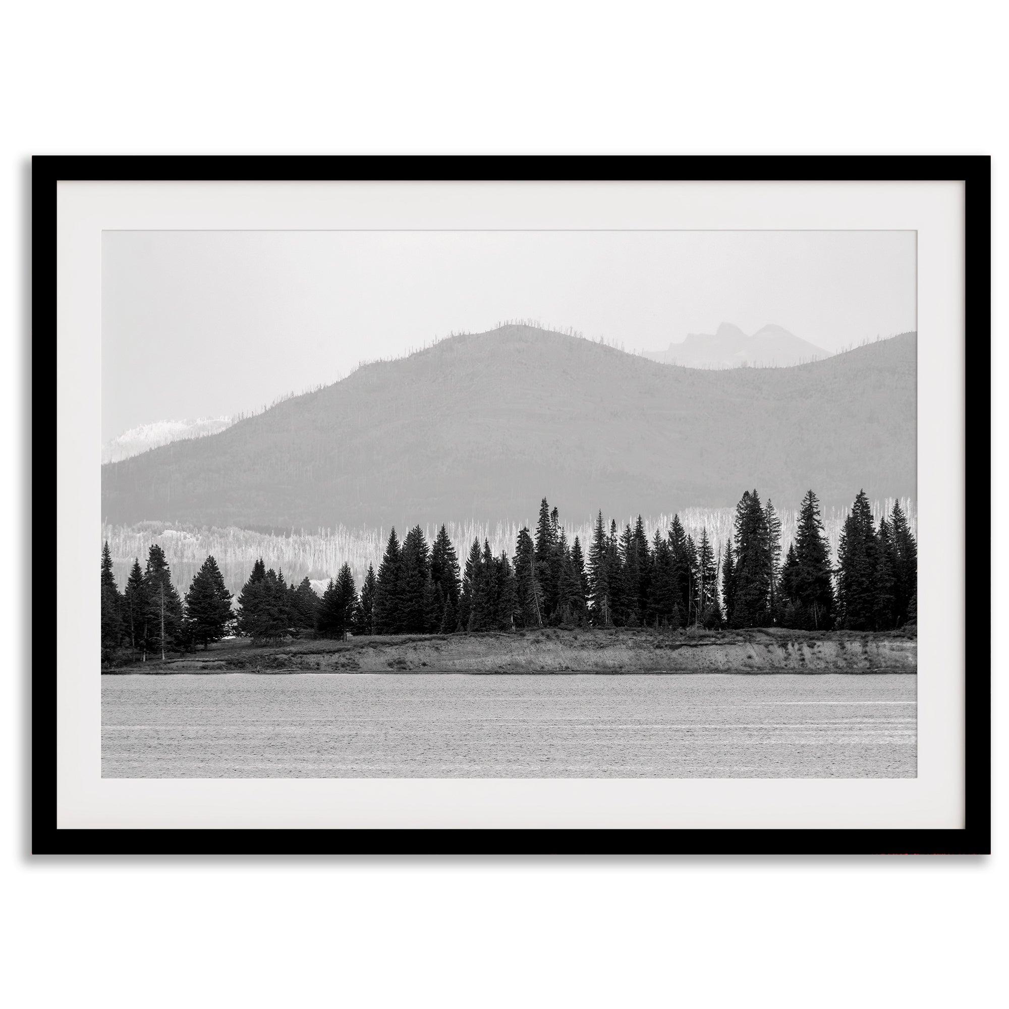 Abstract nature art of a forested island on Yellowstone Lake with black-and-white photography and misty mountains.