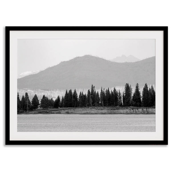 Abstract nature art of a forested island on Yellowstone Lake with black-and-white photography and misty mountains.