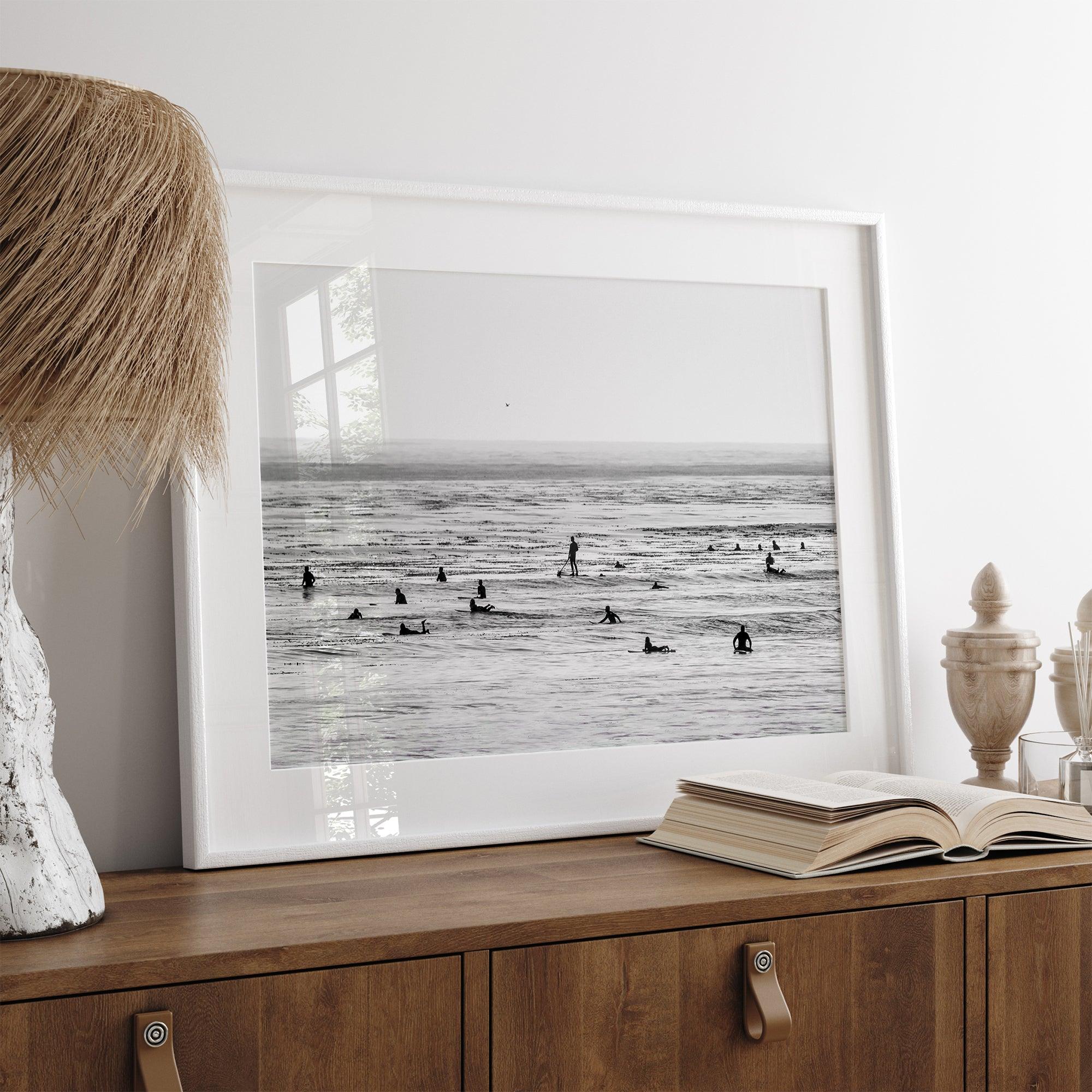 Black and white surf prints showing surfers in calm ocean waters, perfect for beach house wall art or minimalist coastal decor.