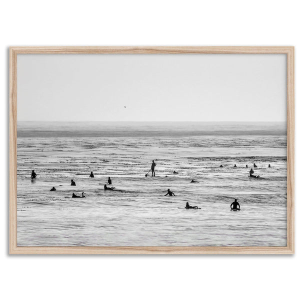 Black and white surf prints showing surfers in calm ocean waters, perfect for beach house wall art or minimalist coastal decor.