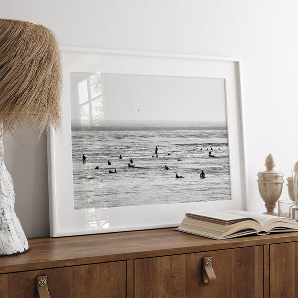 Black and white surf prints showing surfers in calm ocean waters, perfect for beach house wall art or minimalist coastal decor.