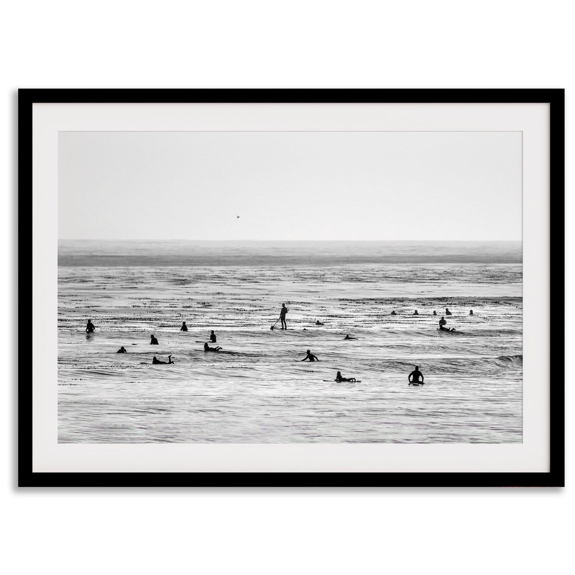 Black and white surf prints showing surfers in calm ocean waters, perfect for beach house wall art or minimalist coastal decor.