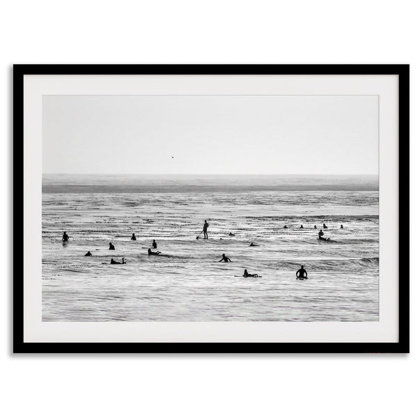 Black and white surf prints showing surfers in calm ocean waters, perfect for beach house wall art or minimalist coastal decor.