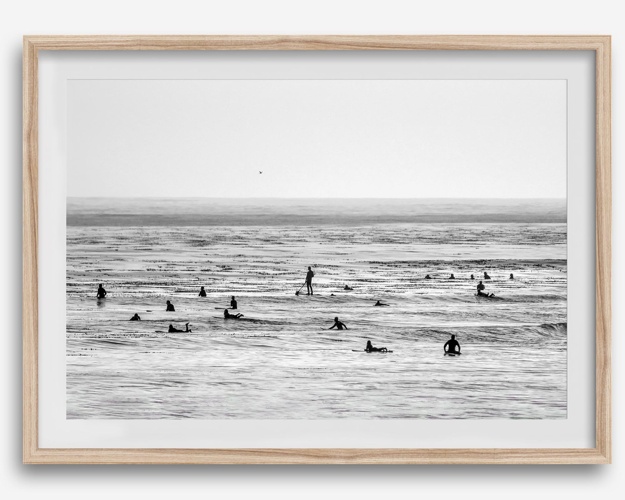 Black and white surf prints showing surfers in calm ocean waters, perfect for beach house wall art or minimalist coastal decor.