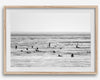Black and white surf prints showing surfers in calm ocean waters, perfect for beach house wall art or minimalist coastal decor.