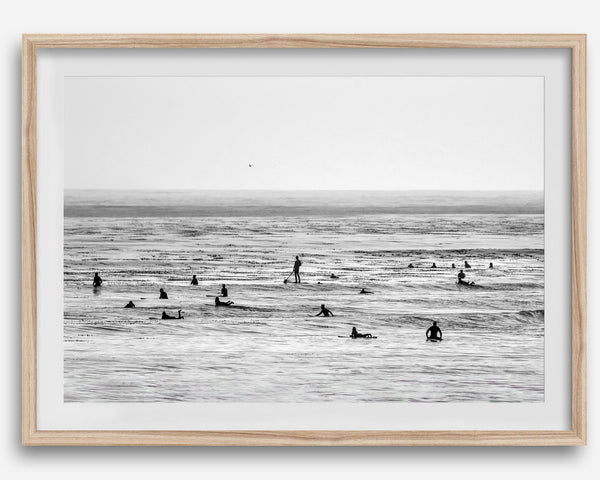 Black and white surf prints showing surfers in calm ocean waters, perfect for beach house wall art or minimalist coastal decor.
