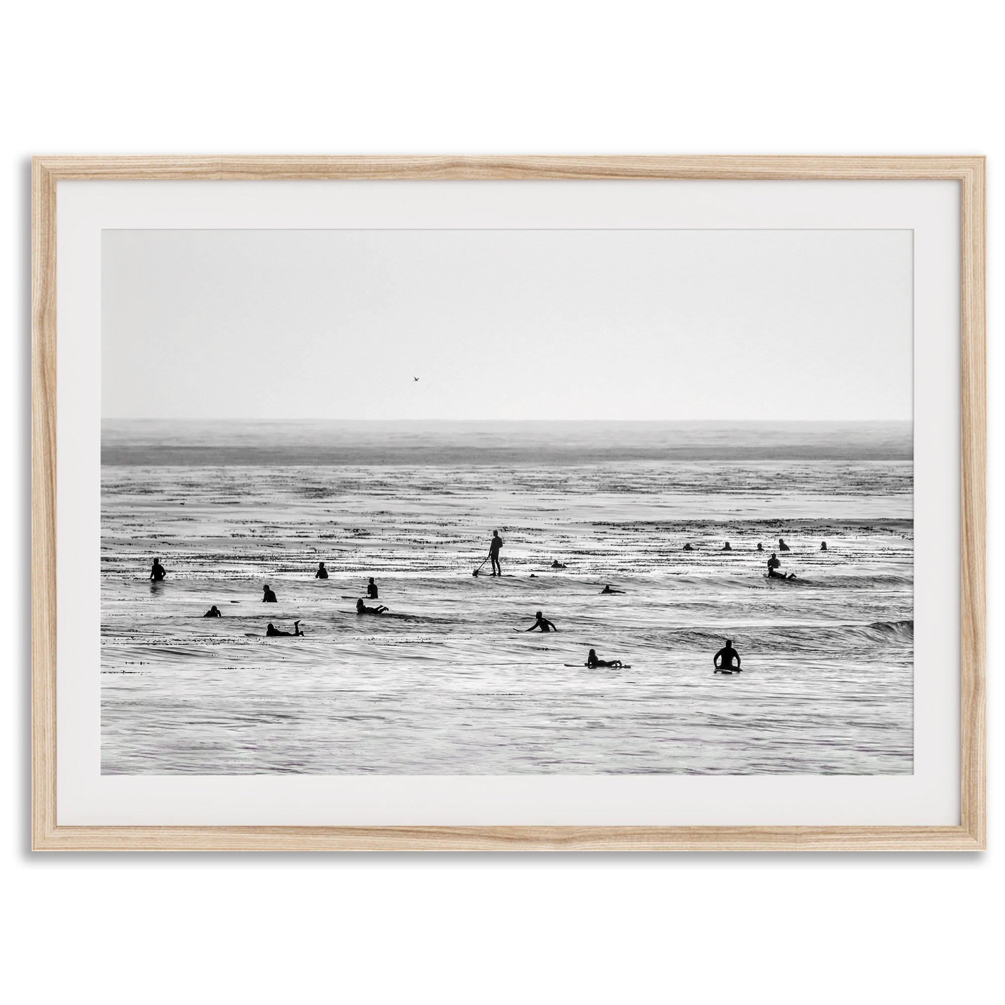 Black and white surf prints showing surfers in calm ocean waters, perfect for beach house wall art or minimalist coastal decor.