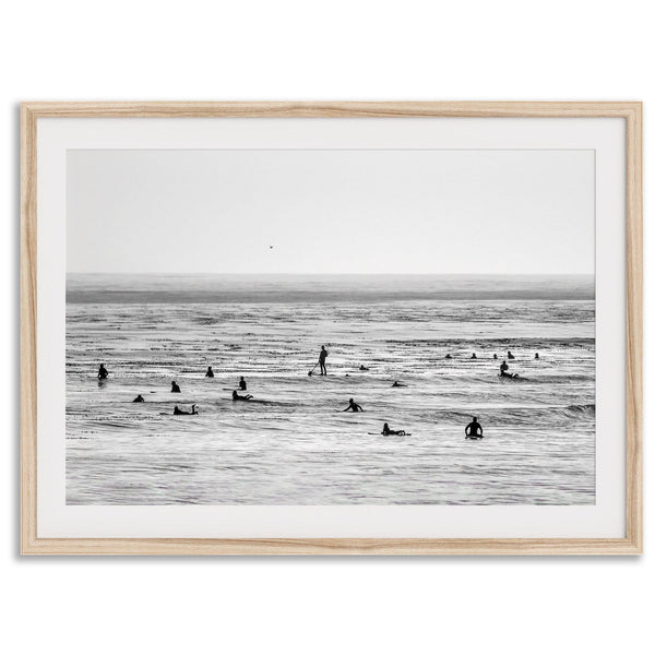 Black and white surf prints showing surfers in calm ocean waters, perfect for beach house wall art or minimalist coastal decor.