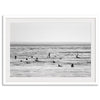 Black and white surf prints showing surfers in calm ocean waters, perfect for beach house wall art or minimalist coastal decor.