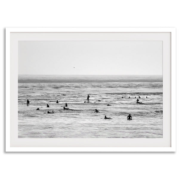 Black and white surf prints showing surfers in calm ocean waters, perfect for beach house wall art or minimalist coastal decor.