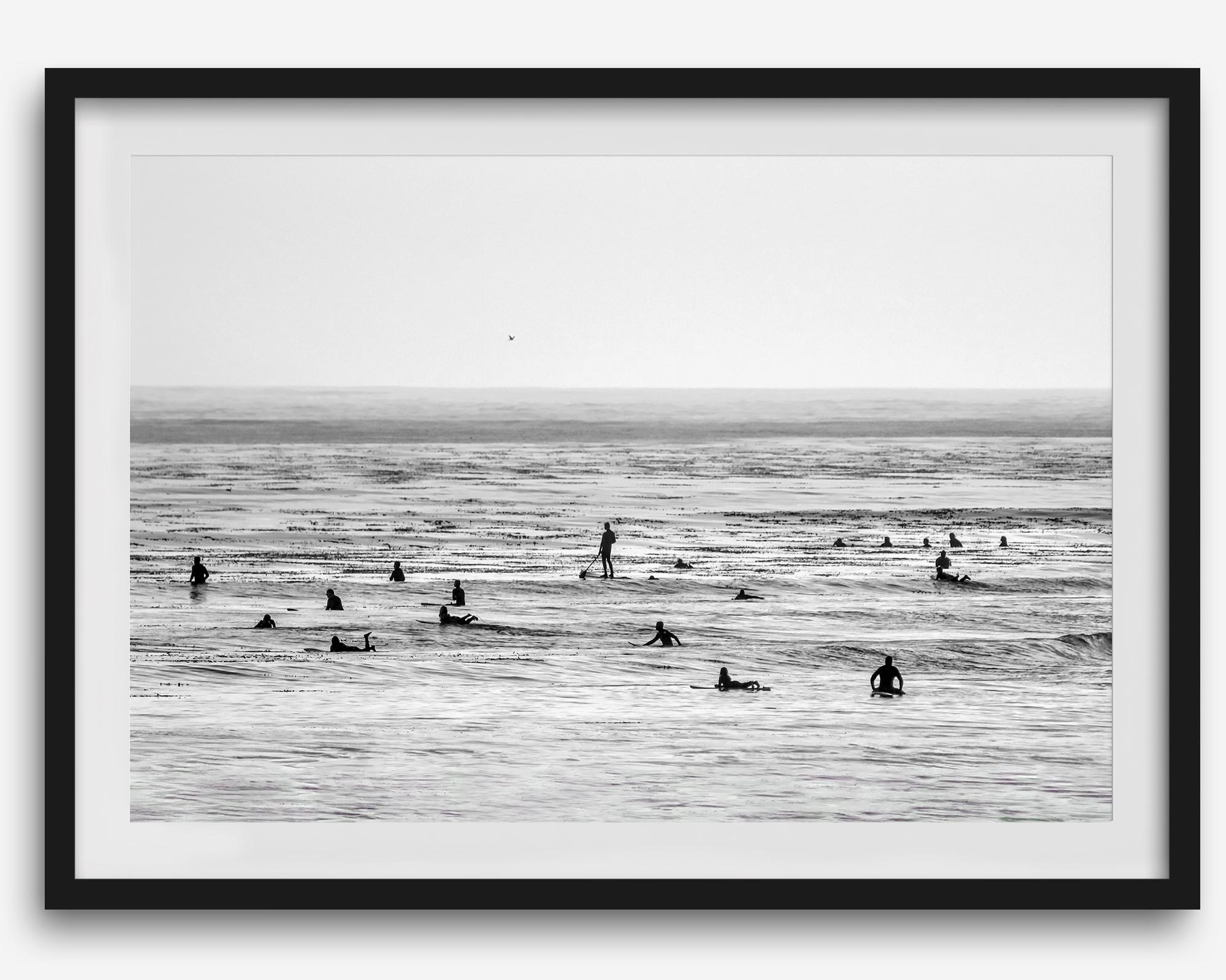 Black and white surf prints showing surfers in calm ocean waters, perfect for beach house wall art or minimalist coastal decor.