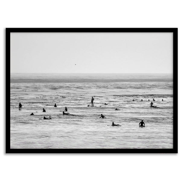 Black and white surf prints showing surfers in calm ocean waters, perfect for beach house wall art or minimalist coastal decor.