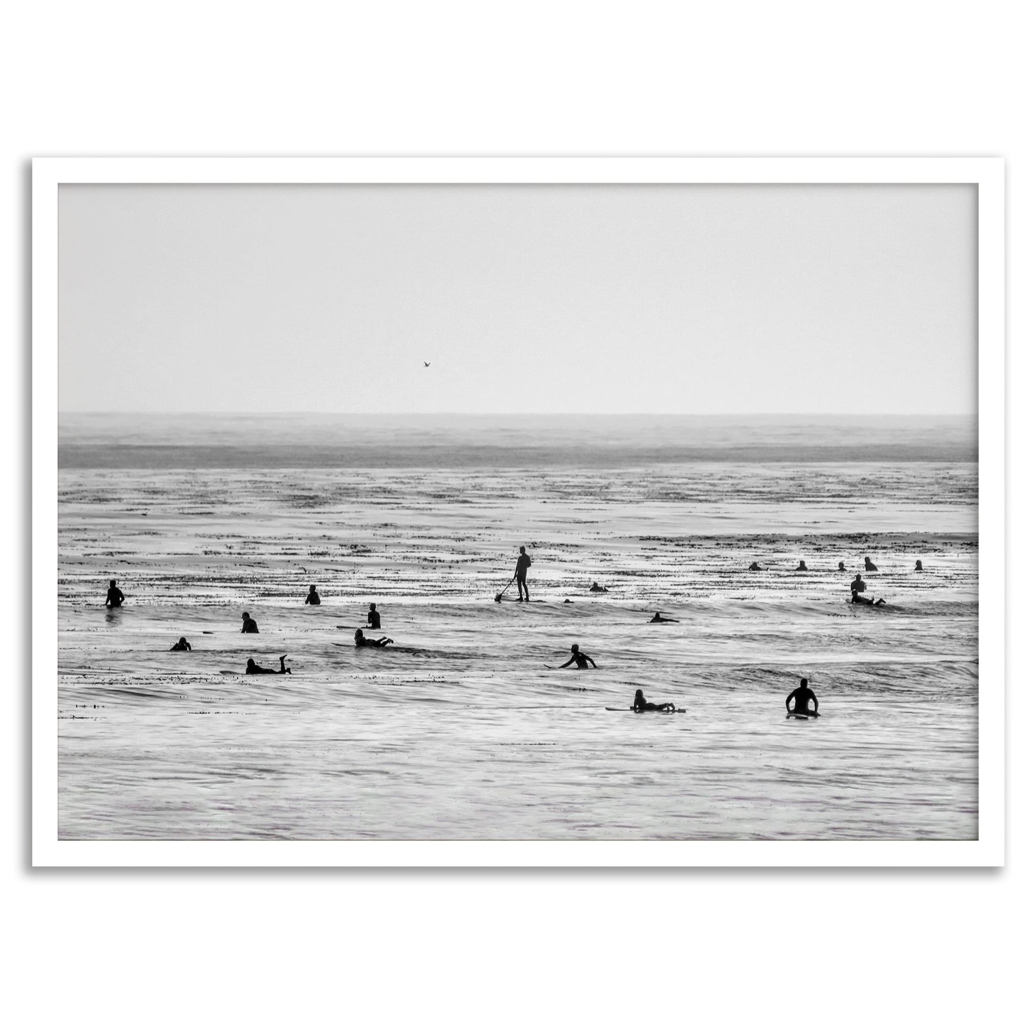 Black and white surf prints showing surfers in calm ocean waters, perfect for beach house wall art or minimalist coastal decor.