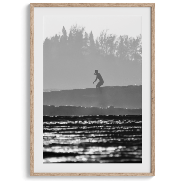Black and white vertical photo print of a surfer riding a wave in Kauai, Hawaii.