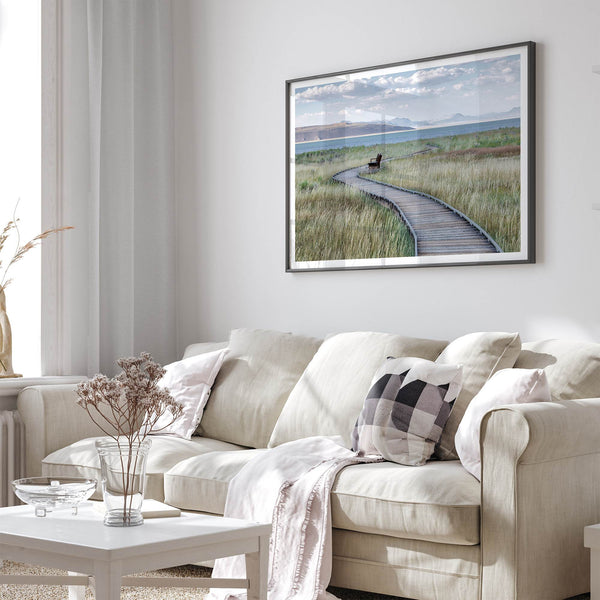 Framed Mono Lake nature photography print featuring a winding boardwalk through tall grasses, leading to a quiet bench beside the lake with mountains in the background.