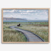 Framed Mono Lake nature photography print featuring a winding boardwalk through tall grasses, leading to a quiet bench beside the lake with mountains in the background.