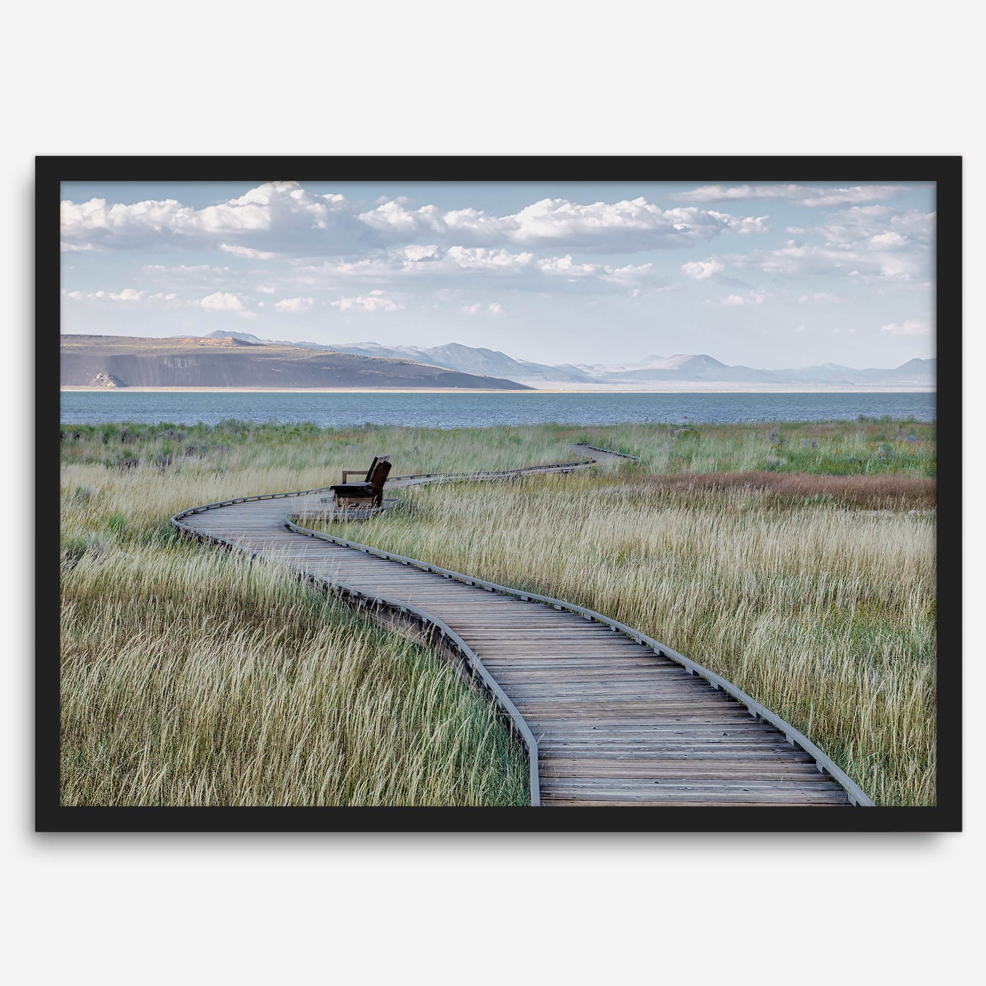 Framed Mono Lake nature photography print featuring a winding boardwalk through tall grasses, leading to a quiet bench beside the lake with mountains in the background.