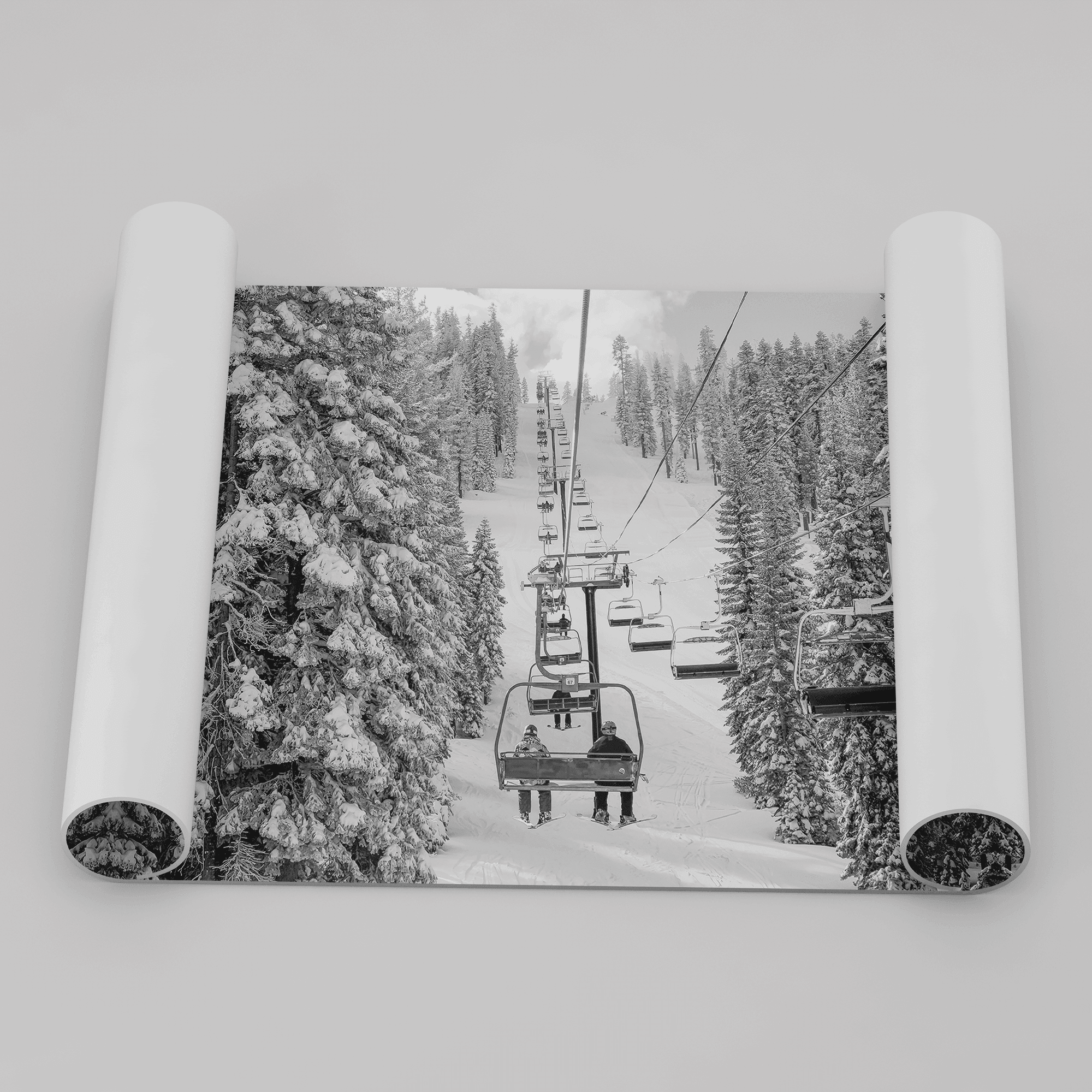 A fine art black and white mountain ski print showing a ski lift winding up the mountain with a stunning winter snow forest around it.