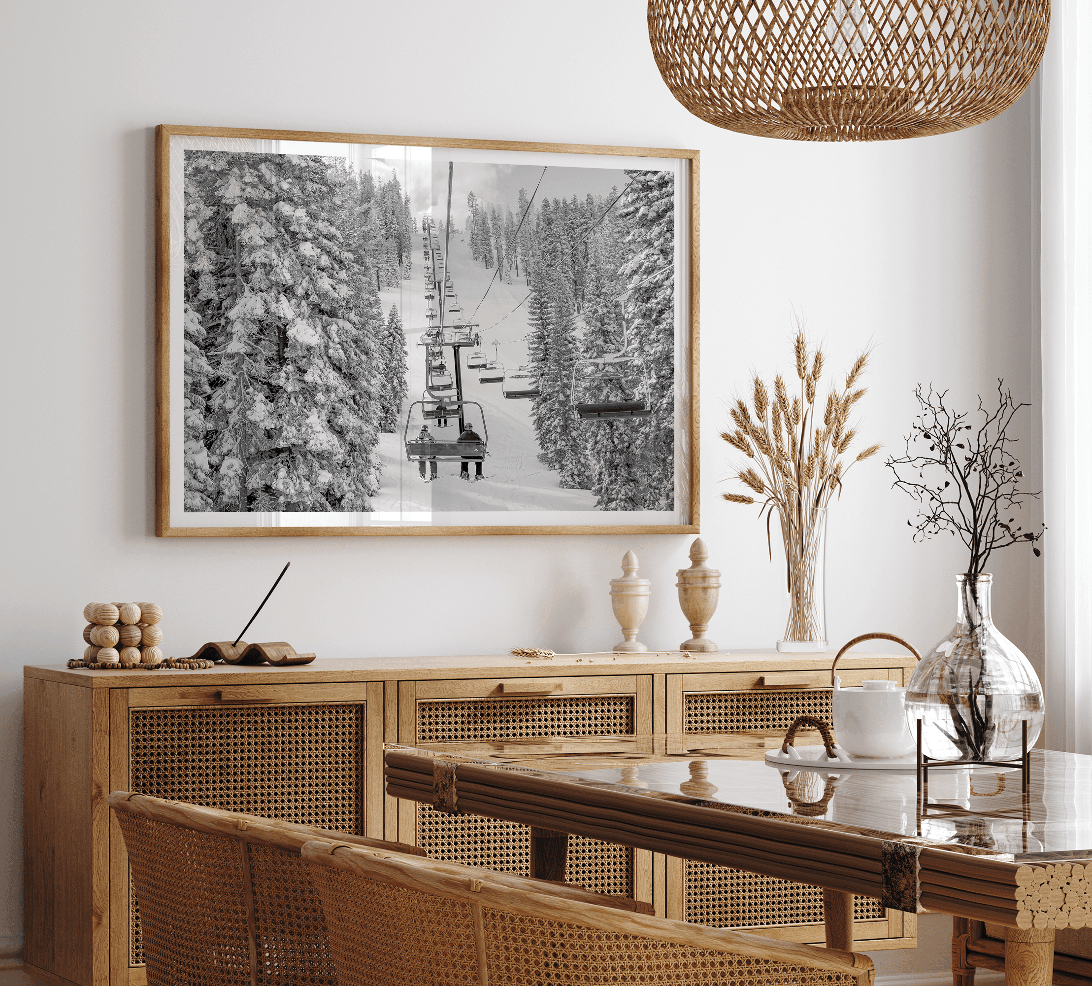 A fine art black and white mountain ski print showing a ski lift winding up the mountain with a stunning winter snow forest around it.