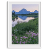 A fine art framed or unframed mountain print of Grand Teton National Park. This portrait orientation nature landscape wall art showcases the beautiful Teton mountains in a pink sunset, with Snake River and stunning flowers in the forefront.