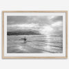 Surfer Wall Art featuring a lone surfer emerging from the ocean at Hanalei Bay in black-and-white photography.
