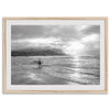 Surfer Wall Art featuring a lone surfer emerging from the ocean at Hanalei Bay in black-and-white photography.