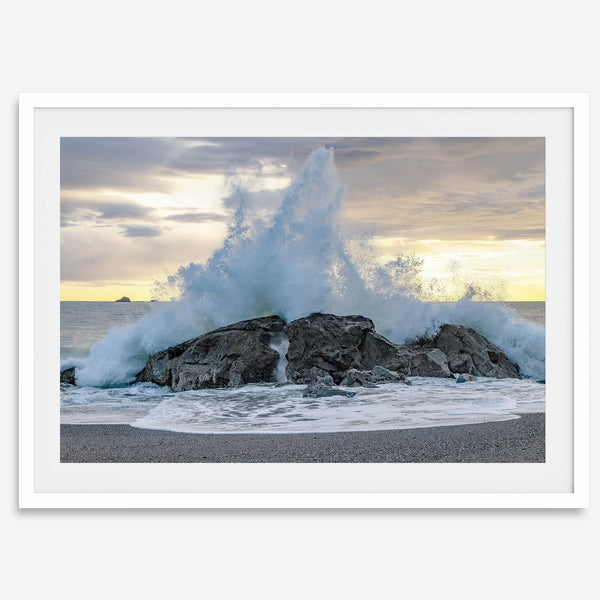 A dramatic fine art beach print showing a huge ocean wave crashing on a beautiful beach in California during sunset
