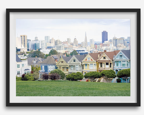 A fine art framed print of the famous colorful painted Ladies Victorian houses in Alamo Square, San Francisco.